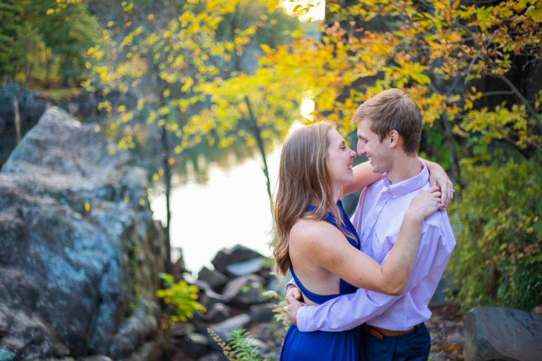 Fall is one of the best times of year to elope in Minnesota. The fall colors turn every view into a stunning backdrop. A couple embrace against the rocky backdrop of Interstate State Park in Taylors Falls, MN.