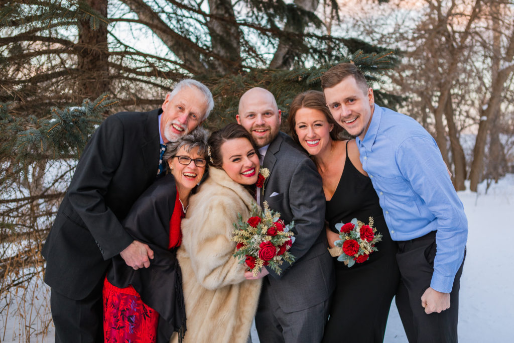 A family snuggles close to stay warm during a winter elopement