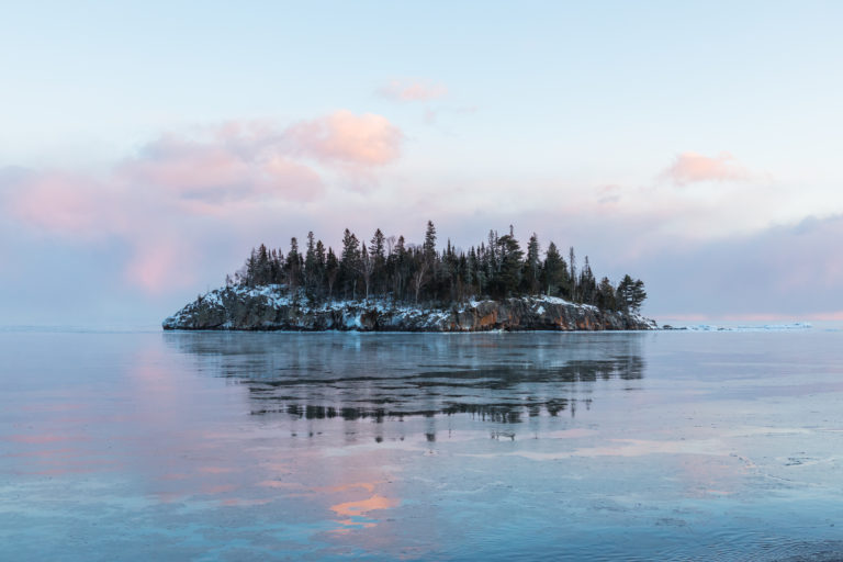 Sunset skies over a Lake Superior island during a cold winter evening.