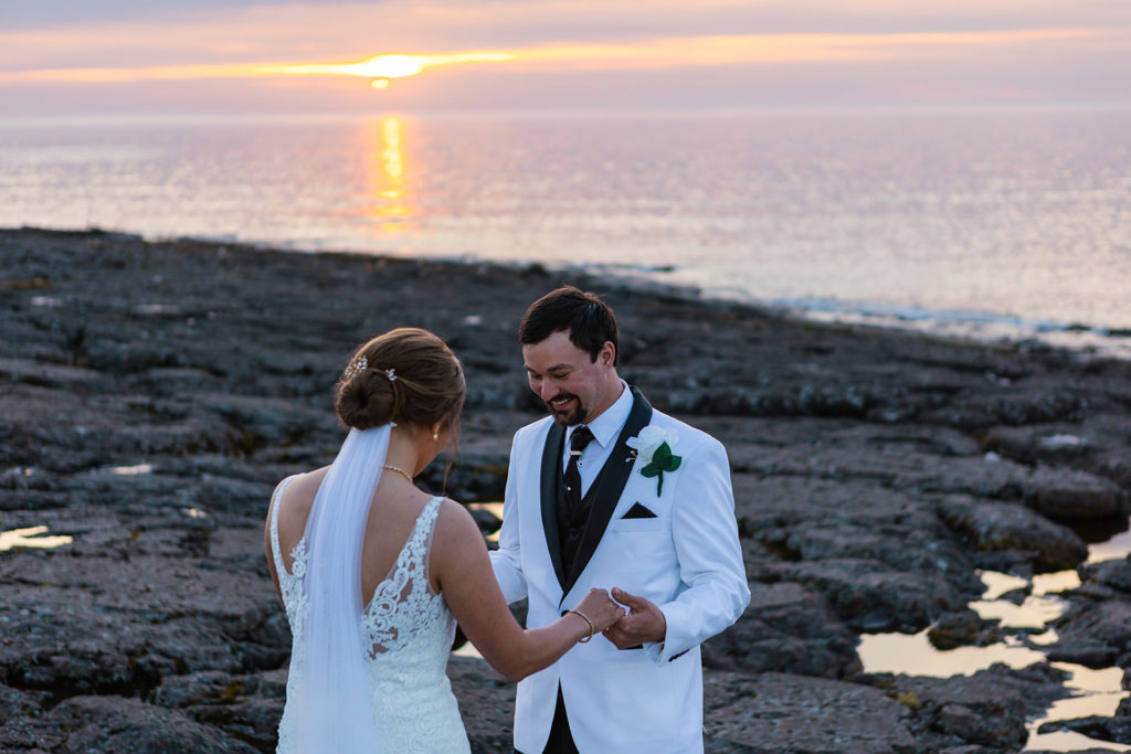 A couple does a sunrise first look during their Gooseberry Falls State Park intimate wedding