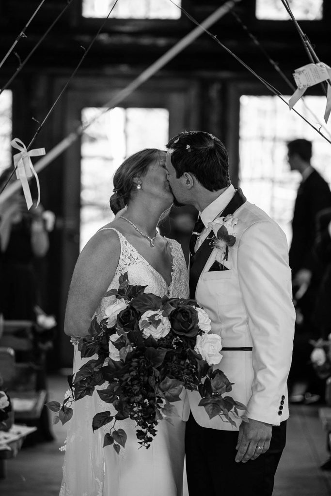 Newlyweds kiss in the Lady Slipper Lodge at Gooseberry State Park in Minnesota