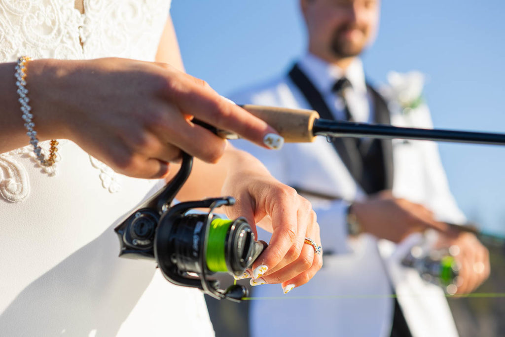 A bride and groom fish together during their north shore fishing elopement.