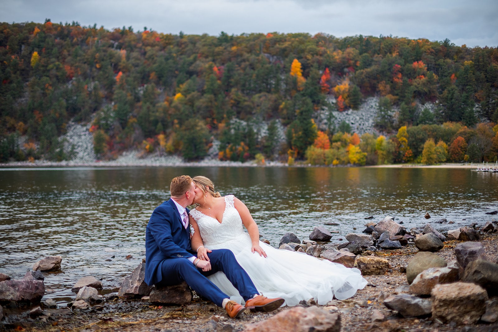 A couple kissed on the shore of Devil's Lake during their elopement at Devil's Lake State Park.
