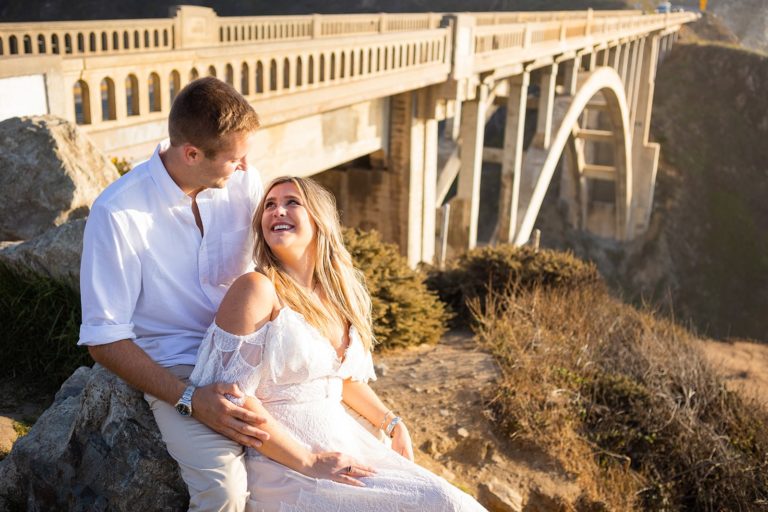 A couple poses in front of one of the iconic Big Sur bridges in California during their elopement on the coast.