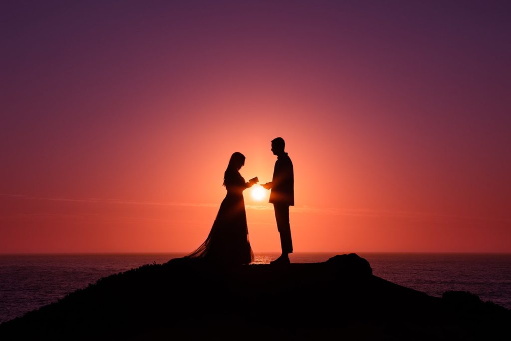 A couple exchanges their vows on a cliff overlooking the ocean during their Big Sur elopement.
