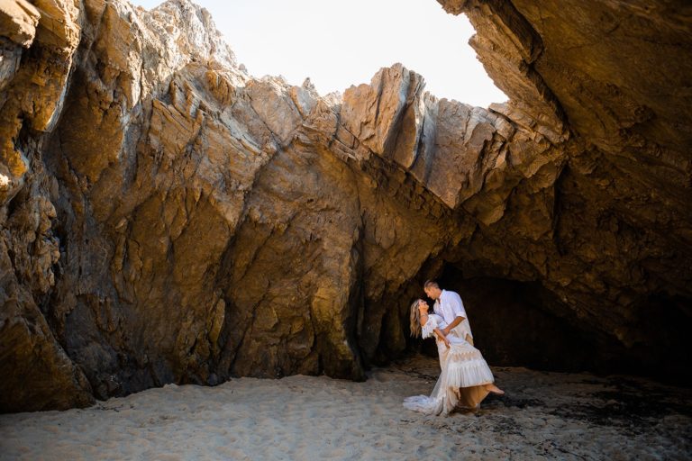 A couple dances in a cave on the beach during their Big Sur Elopement in September.