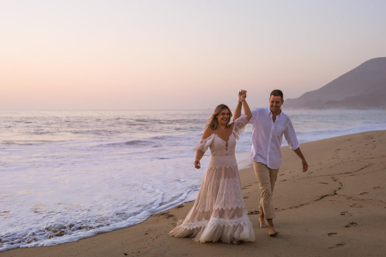 A couple celebrate their elopement on a beach in Big Sur, California.