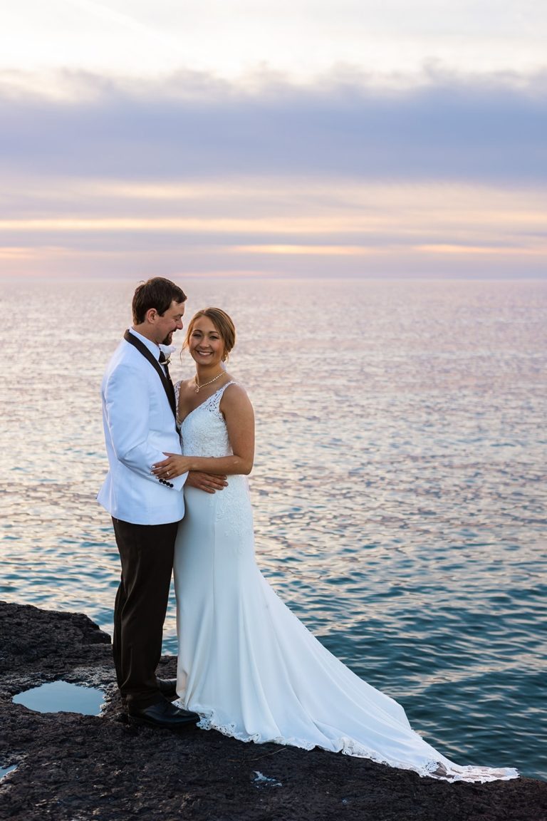 A just married couple celebrate their wedding with an elopement at Gooseberry Falls State Park.