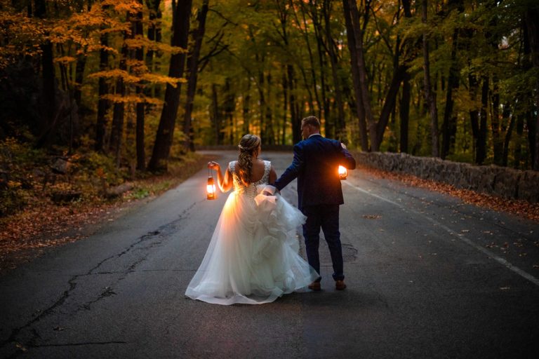 A newly married couple runs down the road at dusk after their Devil's Lake elopement.