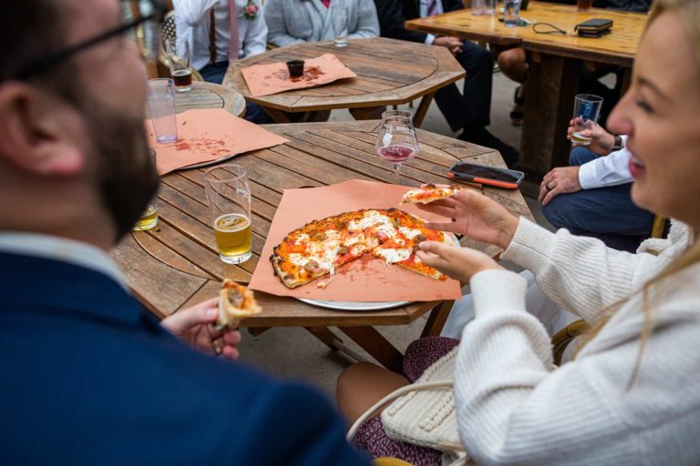 A couple shares a pizza at Ursa Minor Brewing during an elopement in Duluth, MN.