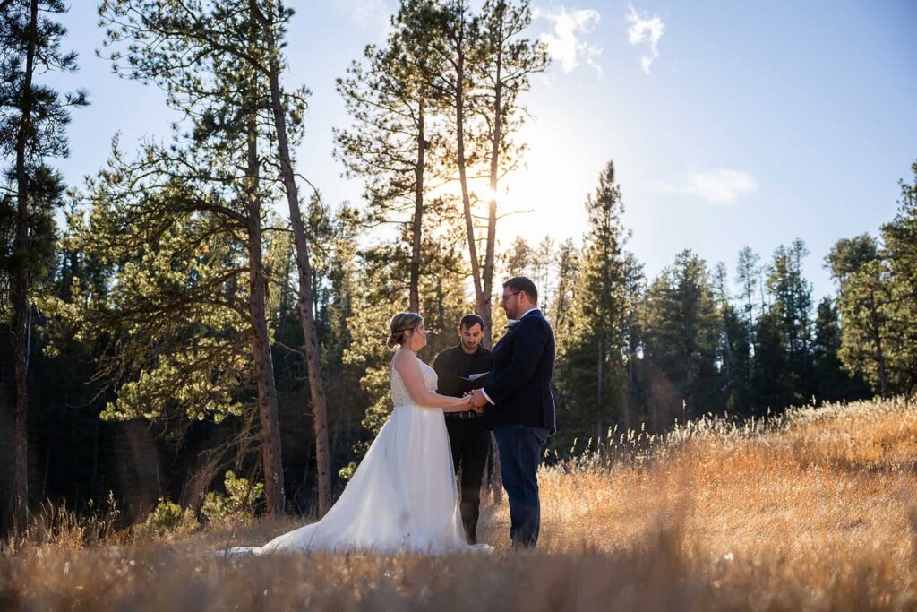 Tucked away in the Black Hills National Forest during their Hill City, SD elopement, a couple exchanges vows during their intimate wedding ceremony.
