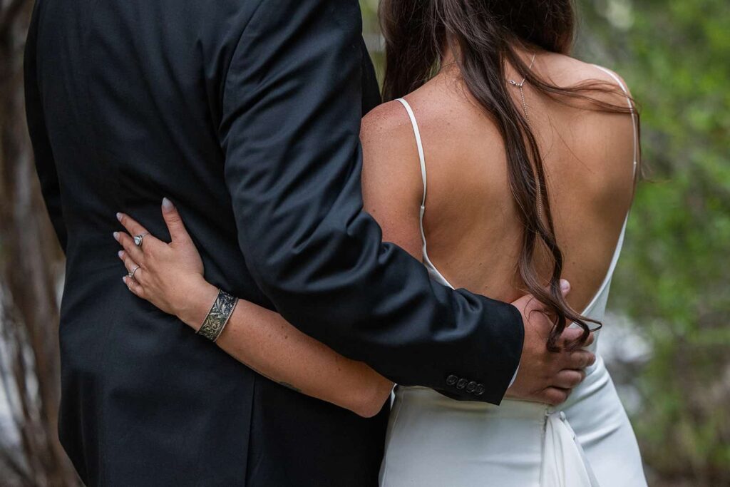 A close up image of a bride and groom embracing during their adventure elopement with Forever and Evergreens.