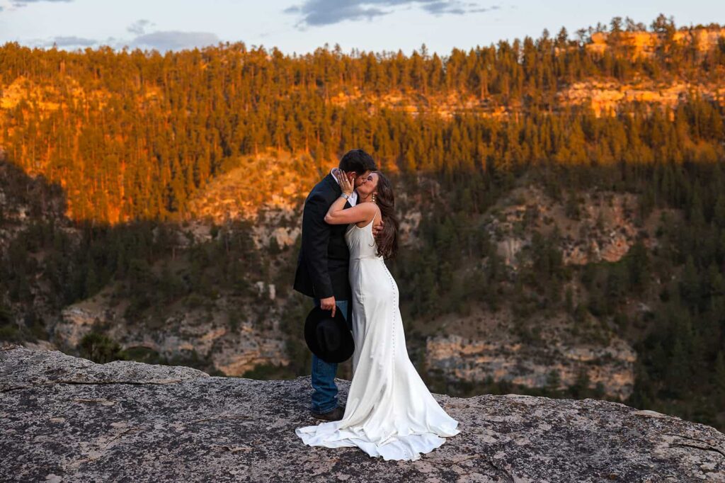 A bride and groom kiss during their western styled Wyoming wedding.