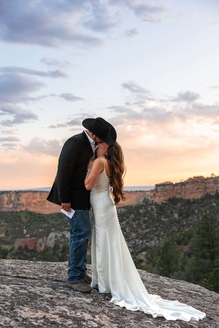 A bride and groom kiss during their western styled Wyoming wedding.