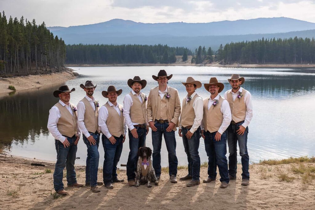 Groomsmen wearing jeans and cowboy hats pose for a picture during a Spear-O-Wigwam wedding.